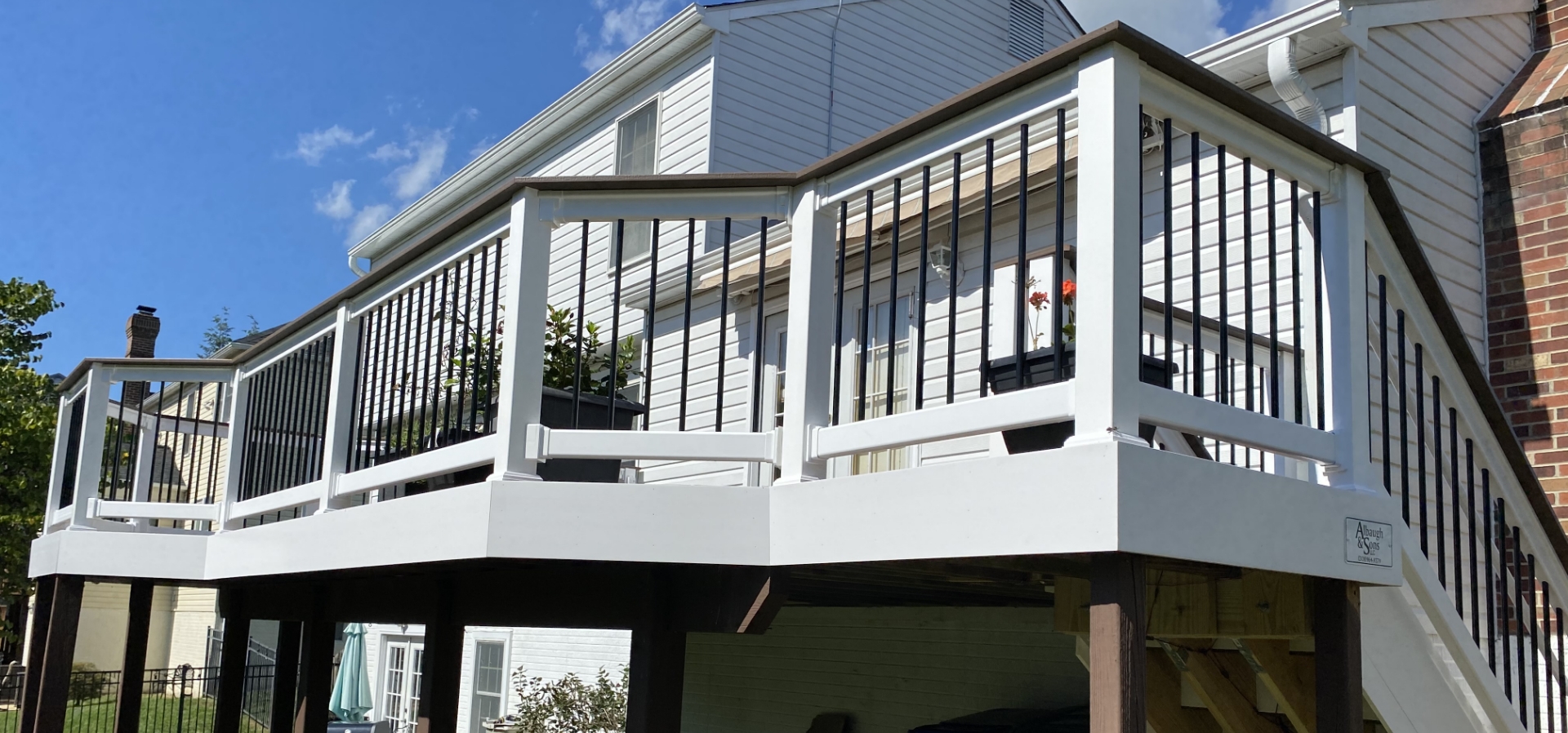 newly installed white deck with brown wood railings